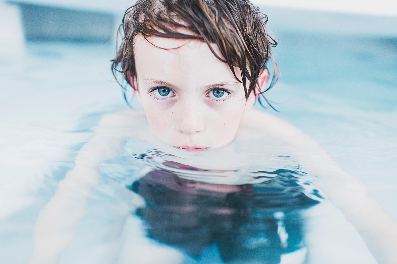 child swimming instructor pool